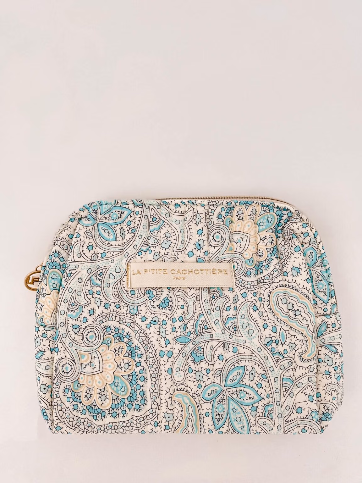 Make-up tas Blue met blokprint in de kleuren crème wit en turquoise van het merk La p'tite Cachottière. De make-up tas ligt op een witte achtergrond.