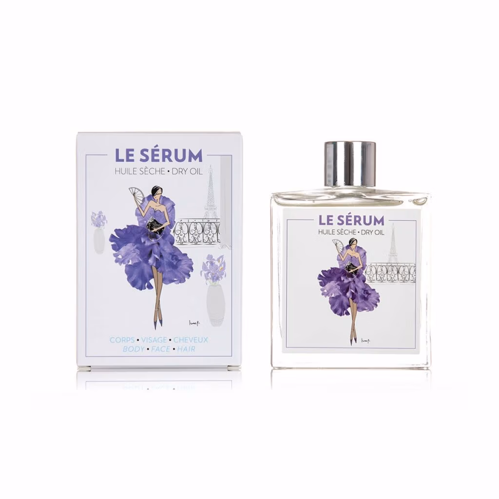 Théophile Berthon Iris en Patchouli Huidolie, glazen fles met label, verpakt in een luxe kartonnen doos met een paarse tekening van een vrouw.