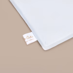 Detail van he tCoco & Cici Bamboe Beddengoed Wit met het label zichtbaar, dat duurzaamheid en luxe combineert voor een comfortabele slaapervaring.