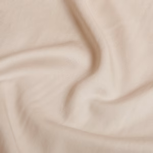 Close-up van de zachte TENCEL™ Twill stof in beige va Coco & Cici die de matte afwerking en textuur van het beddengoed toont.